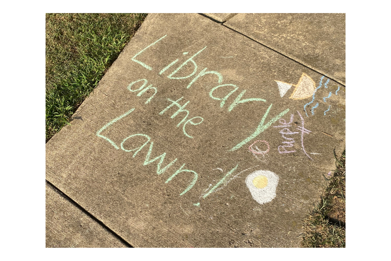 Library on the Lawn written in chalk on the sidewalk