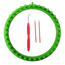 green, round loom with red hook and needles 
