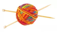 colorful yarn ball with two knitting needles