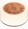 cream colored and circular noise machine with wooden panel middle and buttons